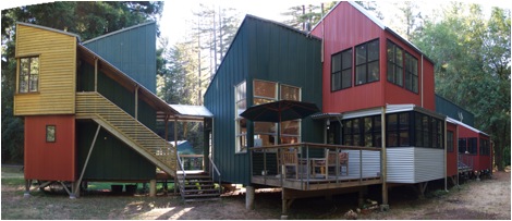 All the buildiings are raised up on stilts to be above the flood plane of a nearby stream. The forms of the buildings are fixed on the courtyard side, however, residents can opt to extend their units on the back side, expressed by different accent colors and materials.